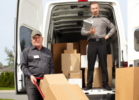 Moving team handling furniture with care during transport