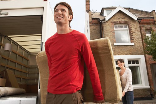 Professional movers carrying furniture in Belgravia